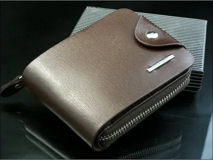 A brown wallet on a black surfaceAI-generated content may be incorrect.